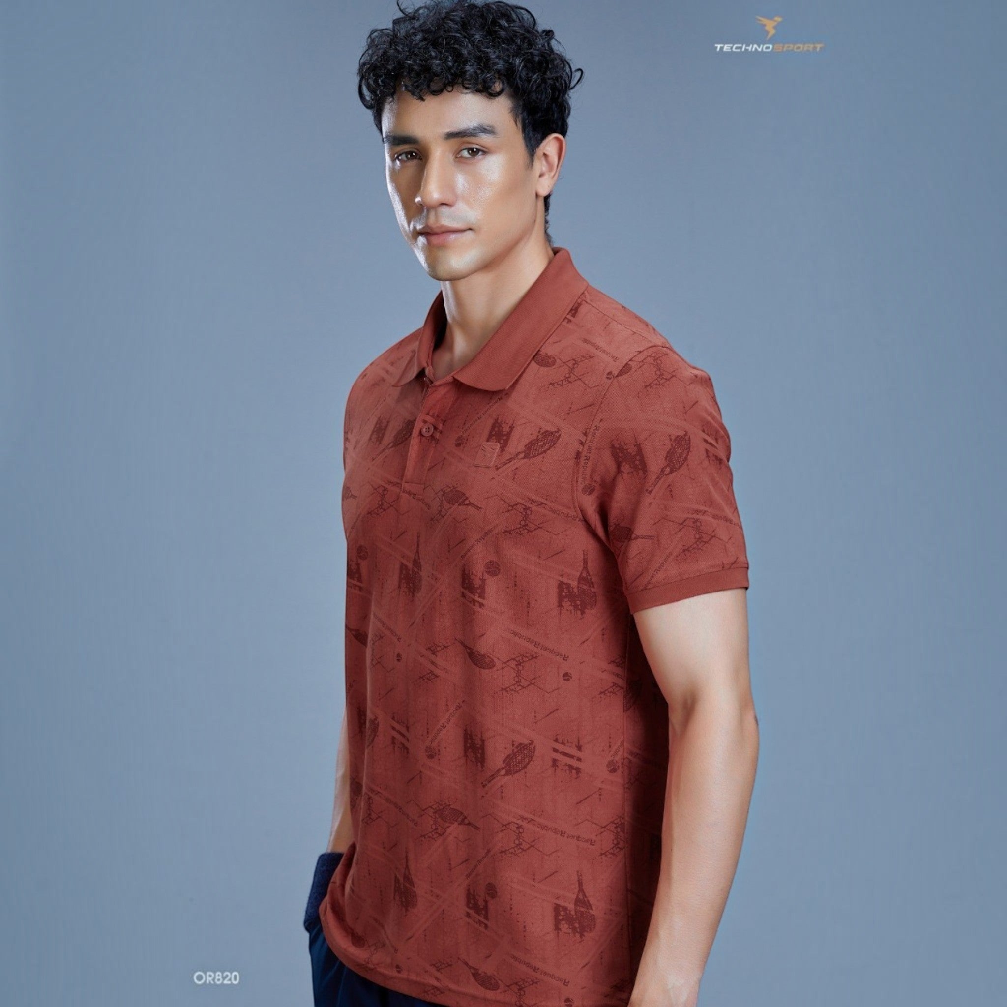 City Center TECHNOSPORTS OR820 rust-coloured performance polo shirt with a subtle geometric print on a male model