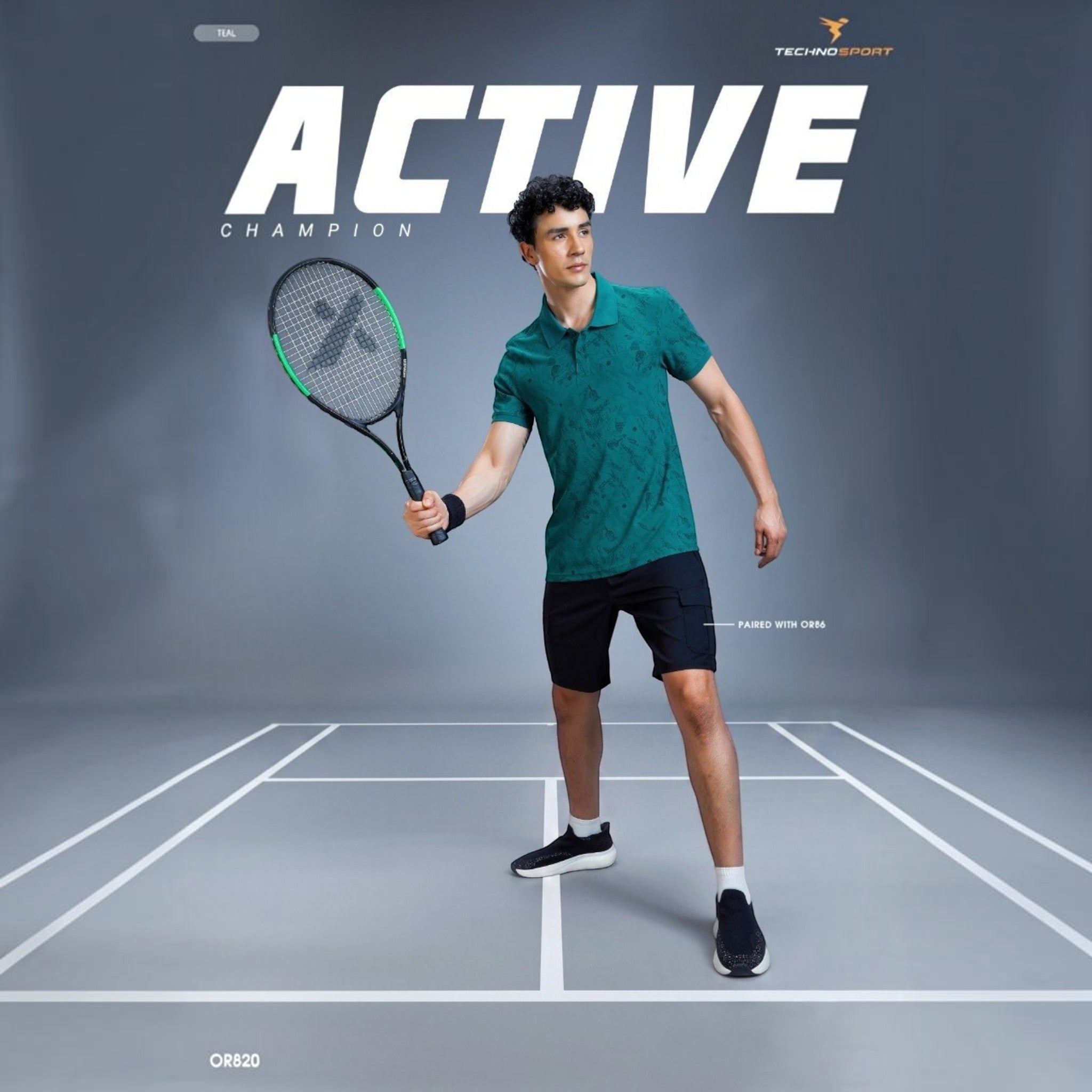 City Center TECHNOSPORTS OR820 teal patterned performance polo shirt worn by a male athlete holding a tennis racket