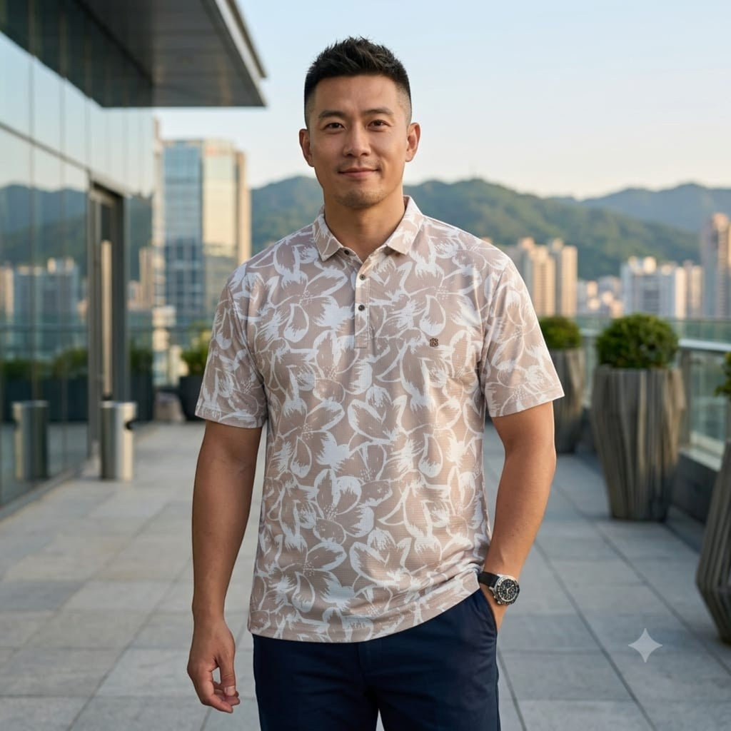 City Center TMG premium men's short-sleeve polo shirt with a beige floral print, worn by a man on a city rooftop.