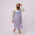 City Center transparent waterproof EVA rain poncho with hood worn by a woman against a white background