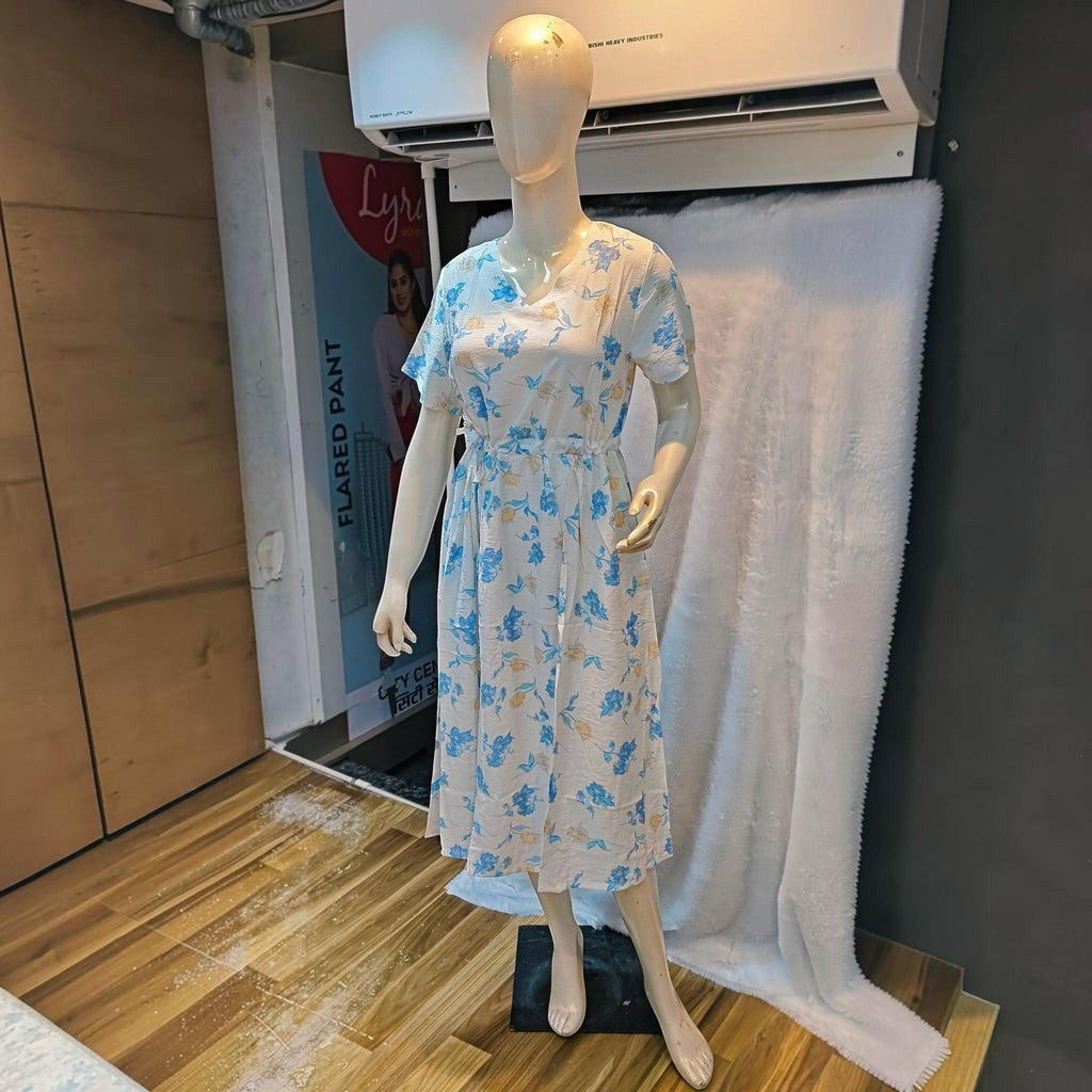 City Center white midi dress with blue floral print, v-neck, and cinched waist on a mannequin