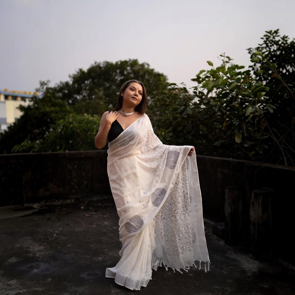City Center white premium cotton saree with grey circular motifs worn by a woman with a black blouse outdoors