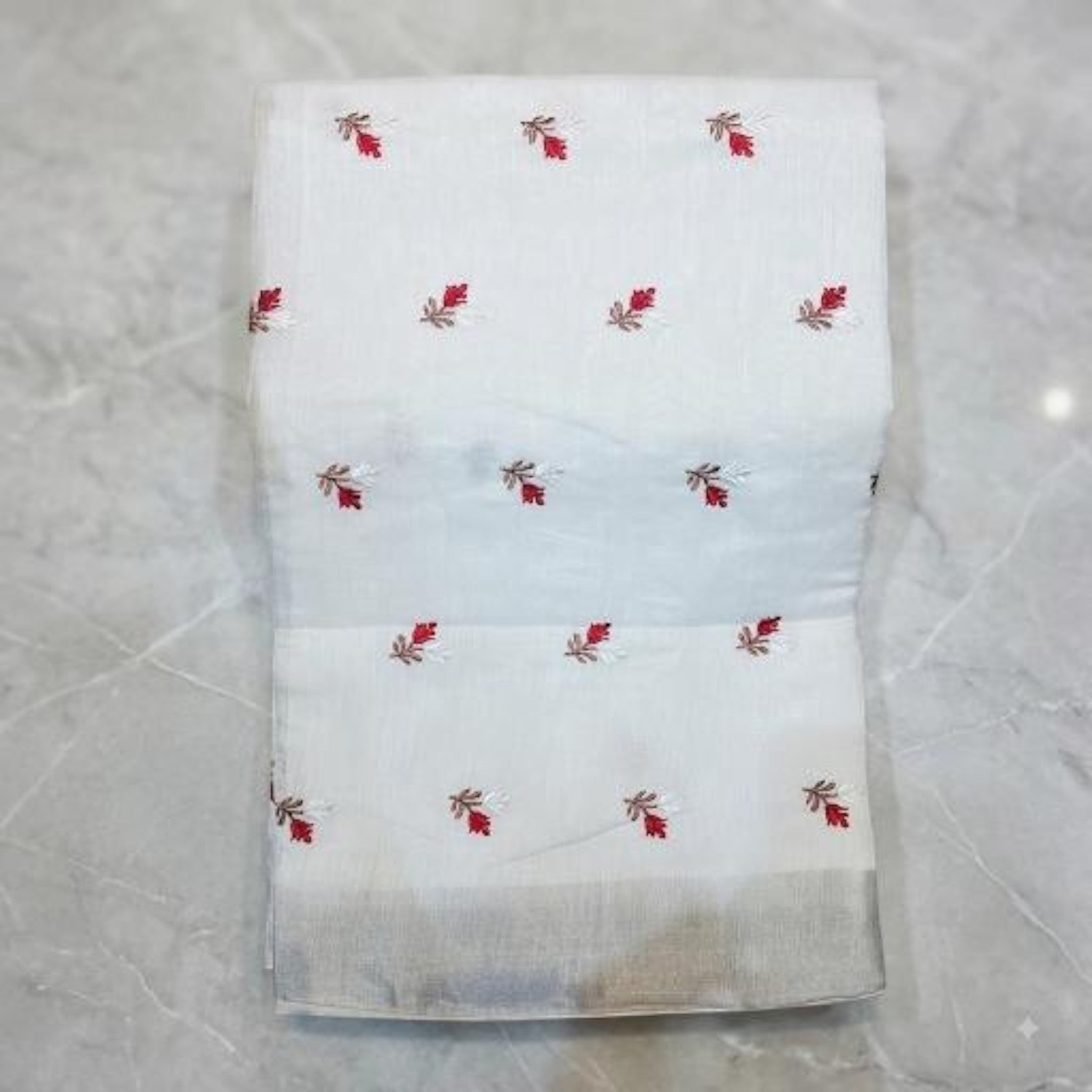 City Center white handwoven South cotton saree with small red floral embroidery and a subtle grey border