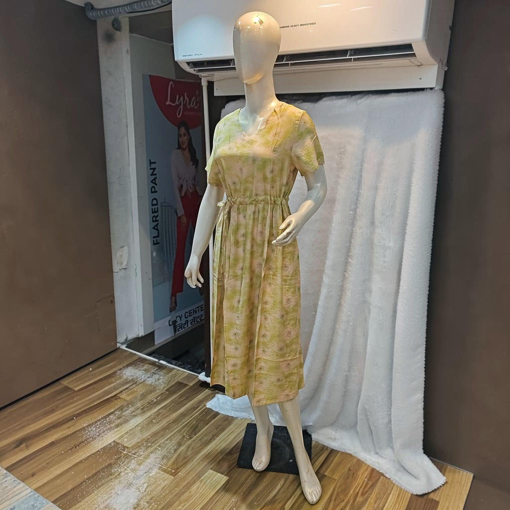 City Center yellow floral print midi dress with a cinched waist and short sleeves on a mannequin
