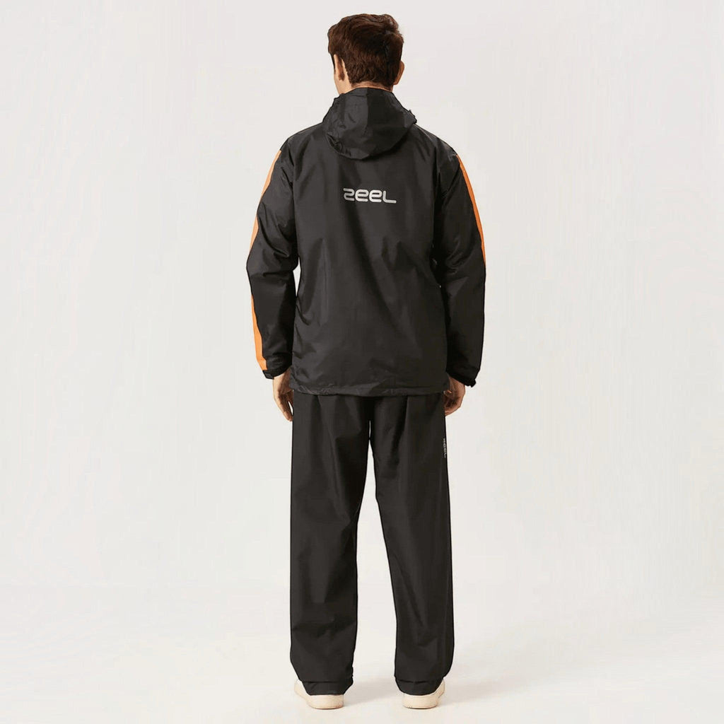 City Center ZEEL premium black waterproof rainsuit with orange side accents worn by a man, back view.