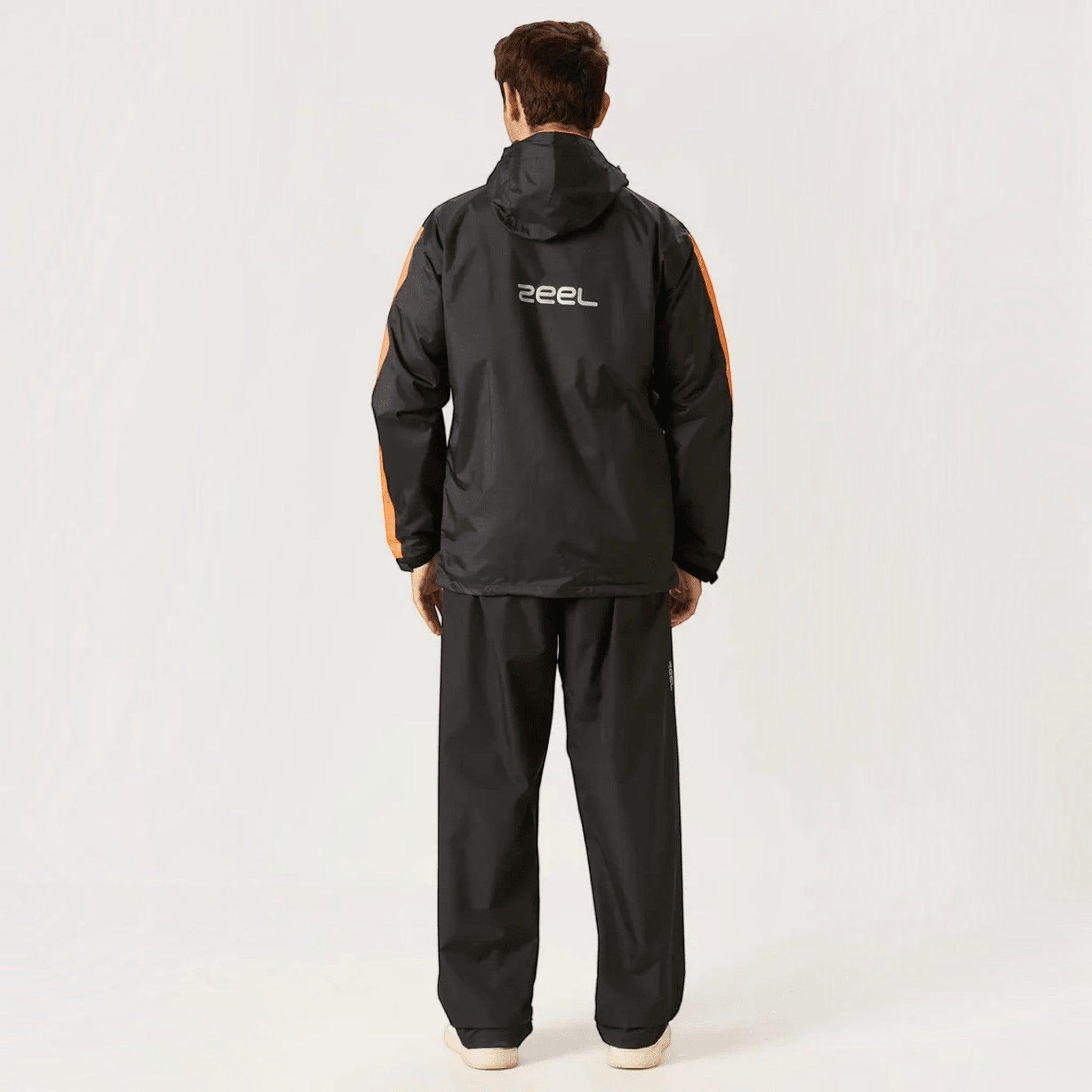 City Center ZEEL premium black waterproof rainsuit with orange side accents worn by a man, back view.