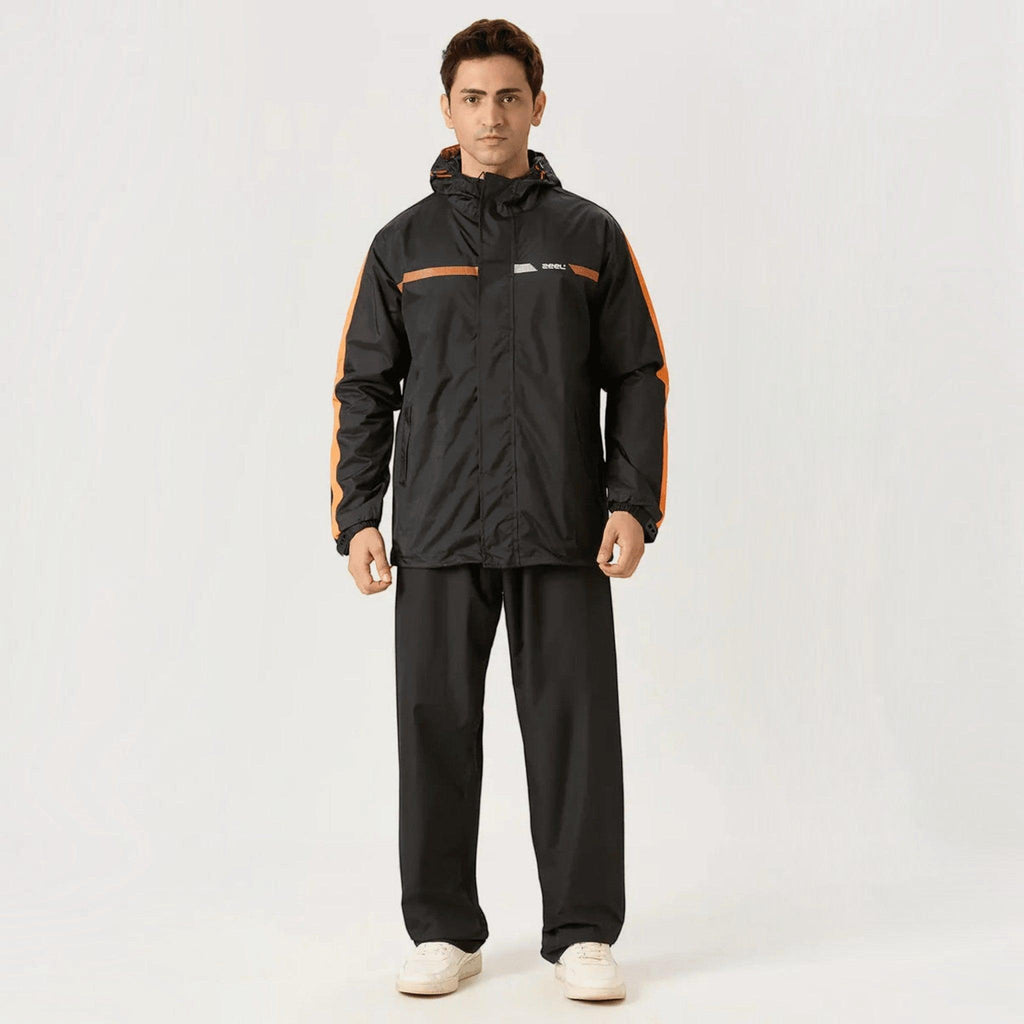 City Center ZEEL premium black waterproof rainsuit with orange side stripes, hood, and full-zip closure on a model.