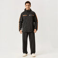 City Center ZEEL premium black waterproof rainsuit with orange side stripes worn by a man against a white background