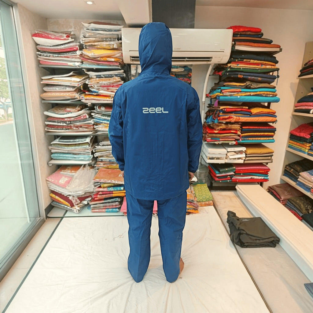 City Center ZEEL premium blue waterproof hooded rainsuit for men seen from the back in a retail store setting.