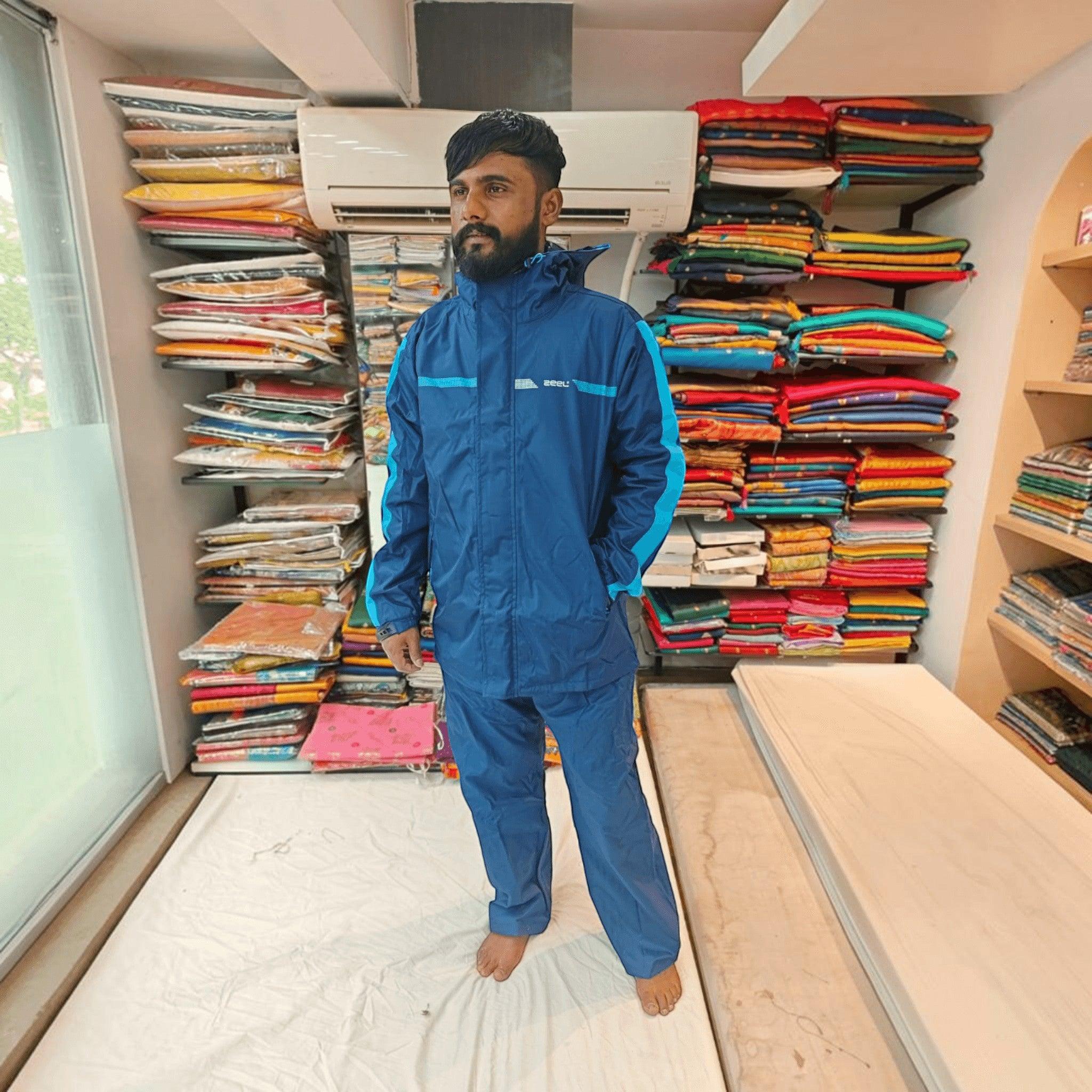 City Center ZEEL premium blue and black waterproof rainsuit with hood and full zipper worn by a man in a shop